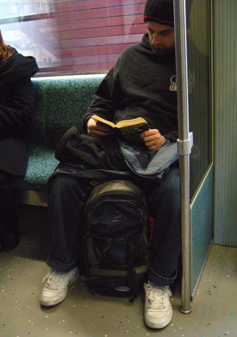 A commuter reading a book on a train