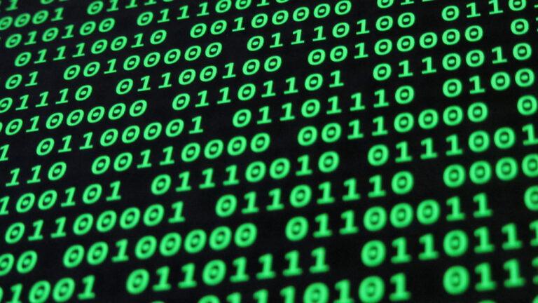 Binary code on a screen representing software automation