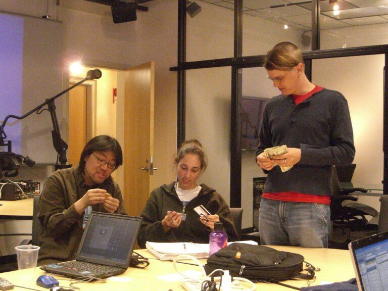 People reviewing finances and cards in an office setting